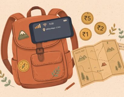 Smartphone with signal icon resting on a backpack with map and coins representing budget travel in India